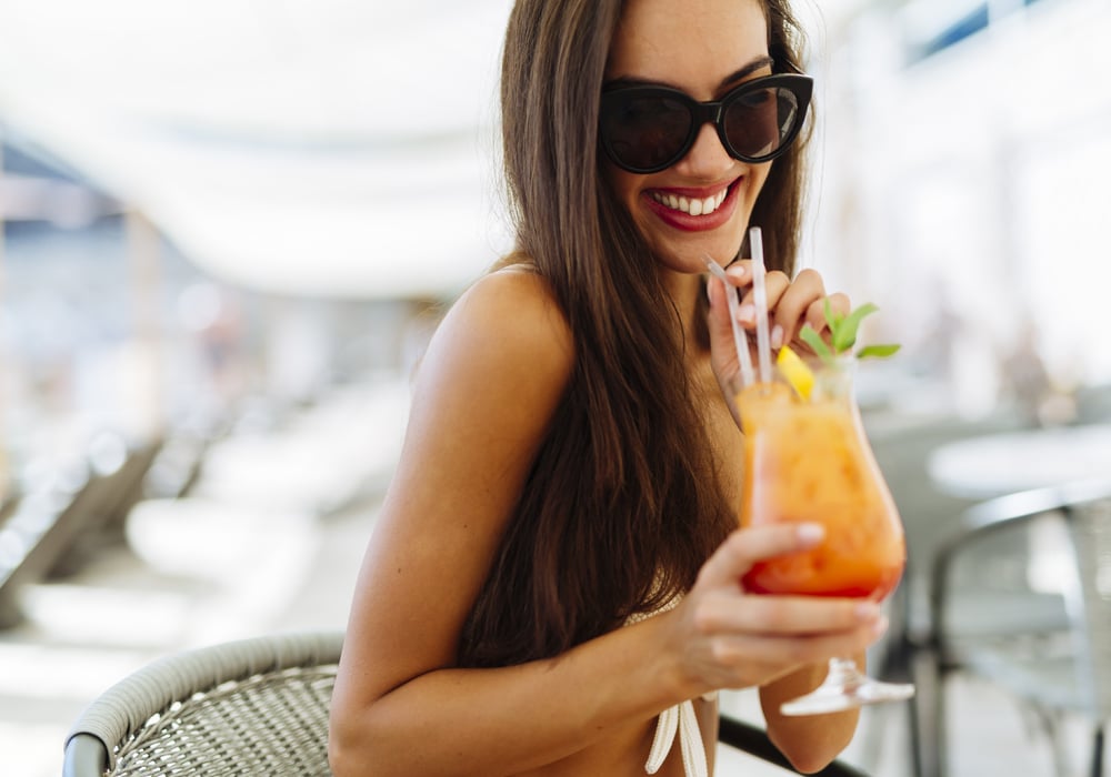 Pretty Woman Enjoying an alcoholic beverage poolside in Costa Rica